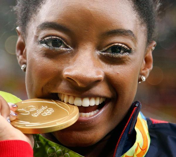 simone-biles_biting-medal_rio-olympics_ap_20160812015512-159532