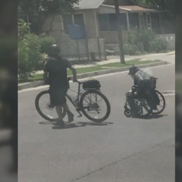 APD officer caught on camera helping man in wheelchair_1557877978858.jpg-846624080.jpg